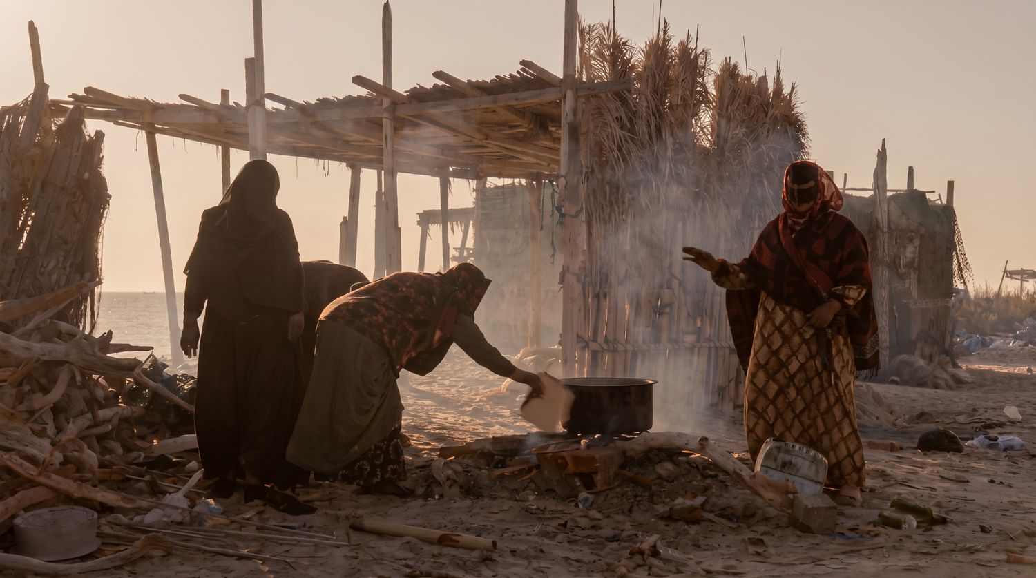 Traditional cooking scene by the coast