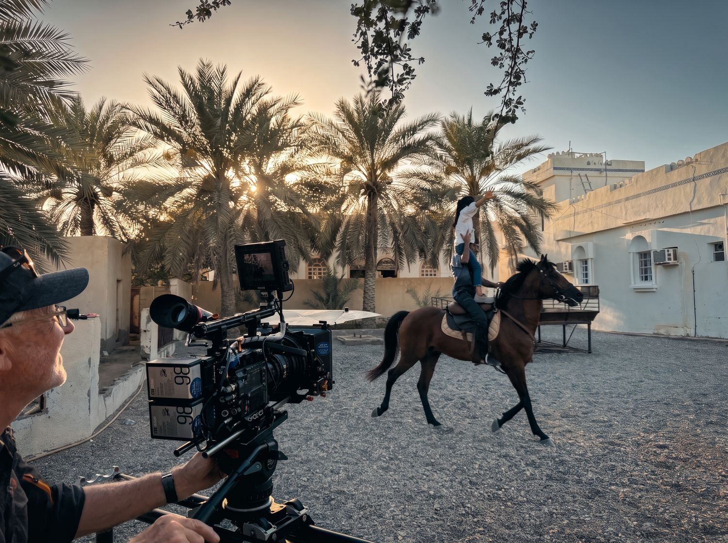 Camera team filming a horse and rider